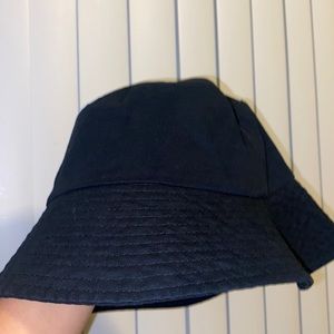 Never worn black bucket hat fits small and medium head sizes.